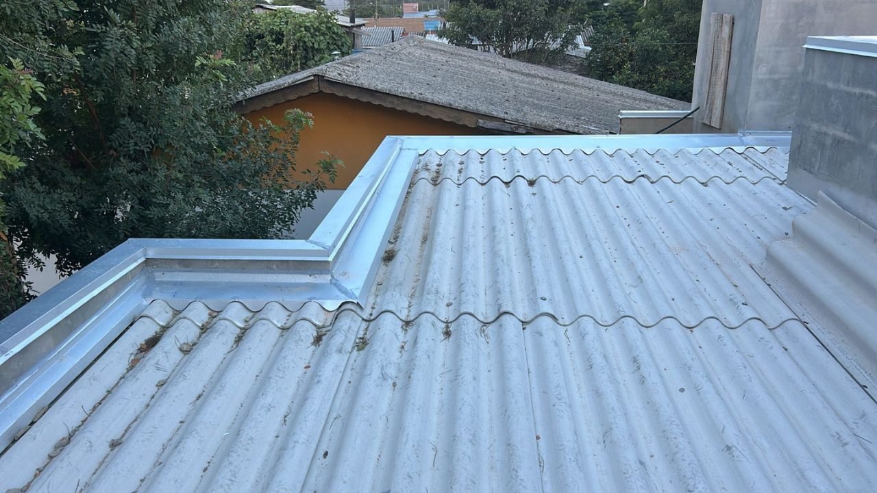 Sistema de calhas instalado ao longo do beiral de um telhado residencial